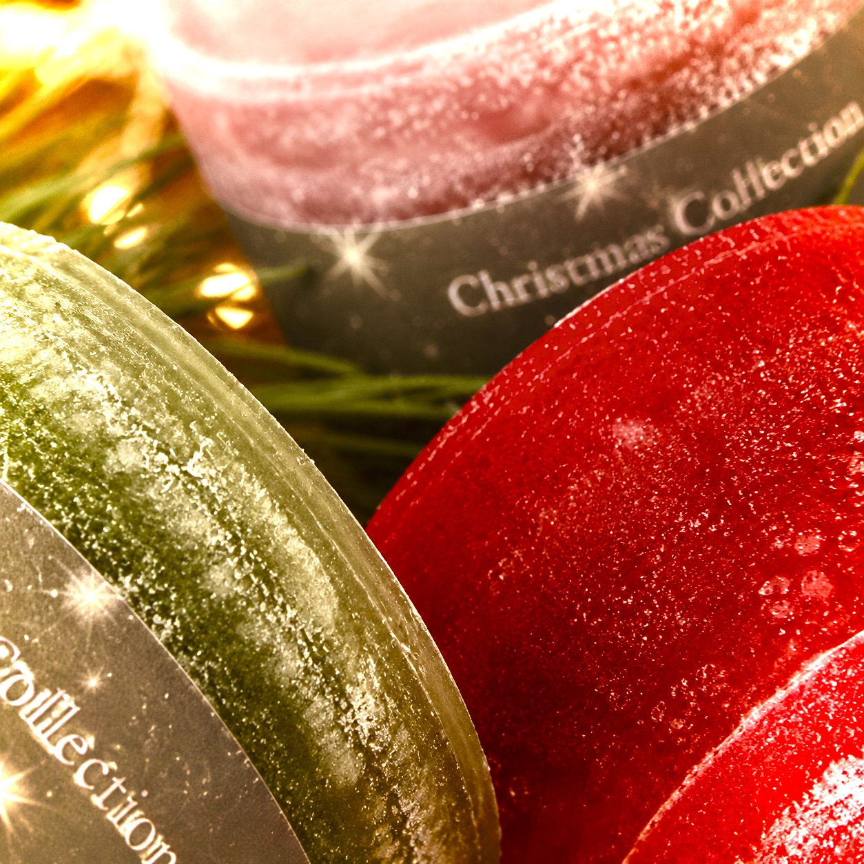 Abstrakte Detailaufnahme der Schulthess Christmas Collection mit roten, grünen und roséfarbenen Duftkerzen
