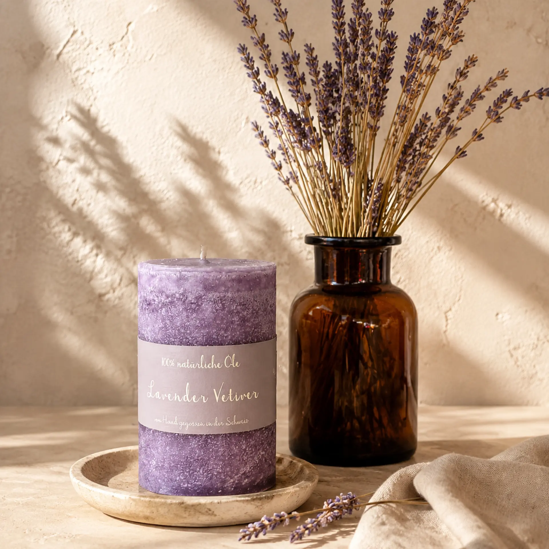 Schulthess Duftkerze Lavender Vetiver mit getrocknetem Lavendel in warmer Naturstein-Kulisse