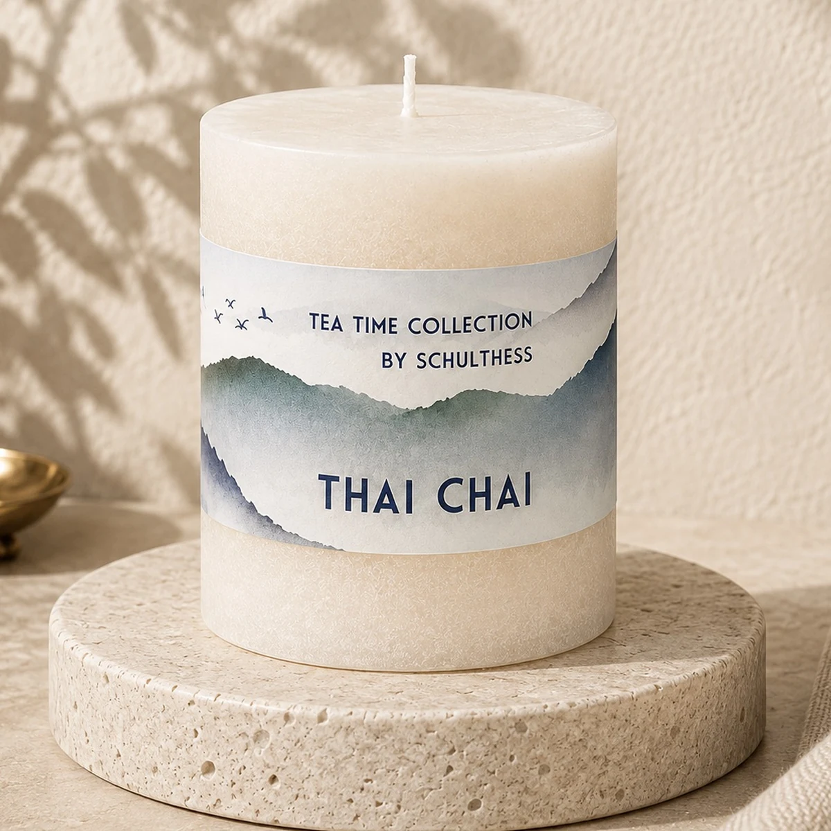 Schulthess Duftkerze Thai Chai aus der Tea Time Collection auf Travertinteller